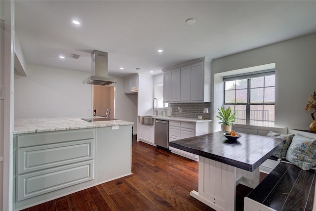 1220 Melony Dr, Sulphur Springs, TX 75482 - kitchen with stainless steel dishwasher, island exhaust hood, decorative backsplash, dark wood-type flooring, and recessed lighting