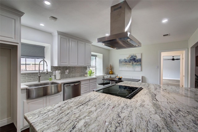 1220 Melony Dr, Sulphur Springs, TX 75482 - kitchen featuring island exhaust hood, dishwasher, a sink, backsplash, and healthy amount of natural light