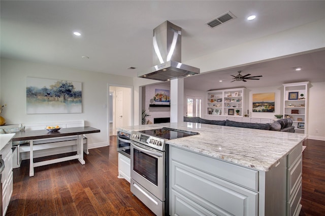1220 Melony Dr, Sulphur Springs, TX 75482 - kitchen featuring electric range, island exhaust hood, open floor plan, dark wood-type flooring, and light stone countertops