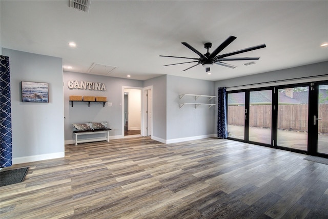 1220 Melony Dr, Sulphur Springs, TX 75482 - unfurnished living room with attic access, wood finished floors, baseboards, ceiling fan, and recessed lighting