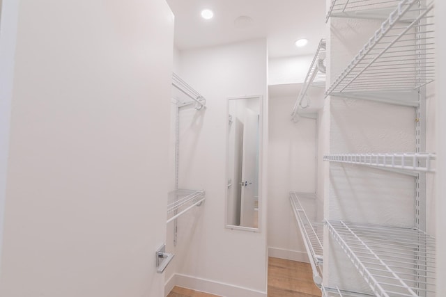 4851 Cedar Springs Rd Unit 175, Dallas, TX 75219 - walk in closet featuring wood finished floors