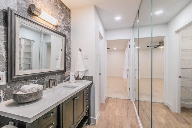 4851 Cedar Springs Rd Unit 175, Dallas, TX 75219 - full bath featuring wood finished floors, vanity, a walk in closet, decorative backsplash, and recessed lighting
