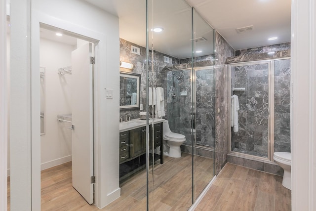 4851 Cedar Springs Rd Unit 175, Dallas, TX 75219 - bathroom featuring toilet, a stall shower, vanity, and recessed lighting