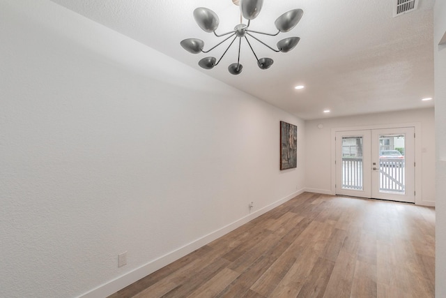 4851 Cedar Springs Rd Unit 175, Dallas, TX 75219 - unfurnished room featuring light wood-style floors, french doors, baseboards, a chandelier, and recessed lighting