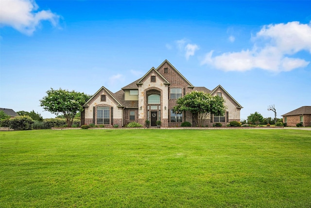 156 Buckskin Dr, Van Alstyne, TX 75495 - view of front facade featuring brick siding, a front lawn, and stone siding
