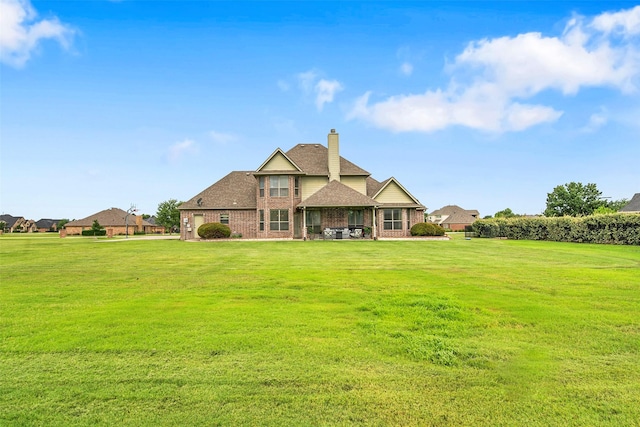 156 Buckskin Dr, Van Alstyne, TX 75495 - rear view of property with brick siding, a lawn, a chimney, and a patio area
