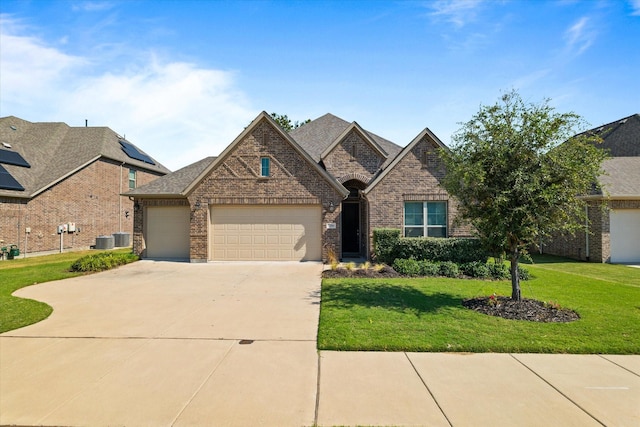 3204 Maplewood Dr, Mckinney, TX 75071 - view of front of house with brick siding, a garage, driveway, and a front yard