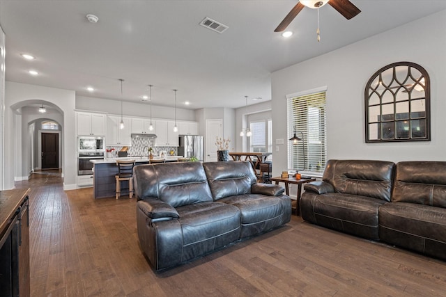 3204 Maplewood Dr, Mckinney, TX 75071 - living room with ceiling fan, dark wood finished floors, arched walkways, and recessed lighting