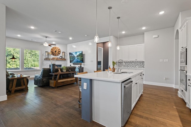 3204 Maplewood Dr, Mckinney, TX 75071 - kitchen featuring stainless steel appliances, open floor plan, light countertops, a ceiling fan, and white cabinetry