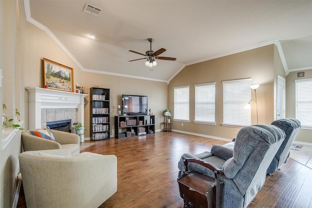 2134 Lorrie Ln, Weatherford, TX 76087 - living room featuring lofted ceiling, healthy amount of natural light, a tiled fireplace, wood finished floors, and a ceiling fan