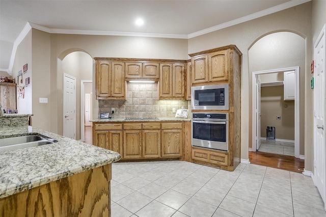 2134 Lorrie Ln, Weatherford, TX 76087 - kitchen with stainless steel oven, built in microwave, a sink, black electric stovetop, and ornamental molding
