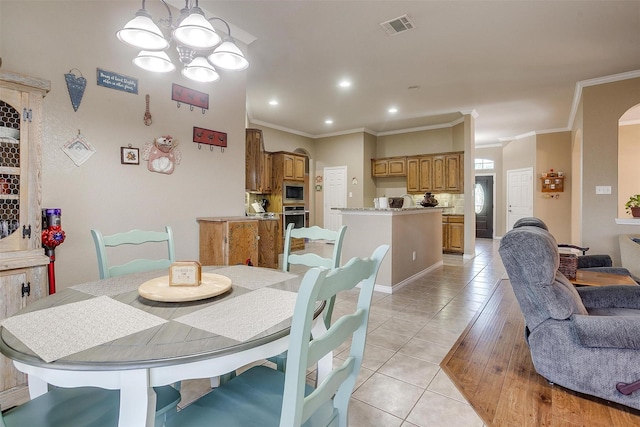 2134 Lorrie Ln, Weatherford, TX 76087 - dining area with light tile patterned flooring, a chandelier, crown molding, and recessed lighting