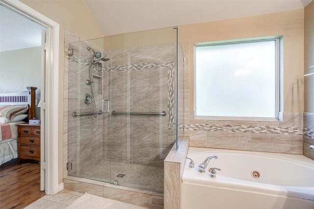 2134 Lorrie Ln, Weatherford, TX 76087 - bathroom featuring a garden tub, a stall shower, ensuite bath, vaulted ceiling, and tile patterned floors