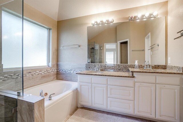 2134 Lorrie Ln, Weatherford, TX 76087 - bathroom featuring double vanity, a shower stall, a whirlpool tub, and tile patterned floors