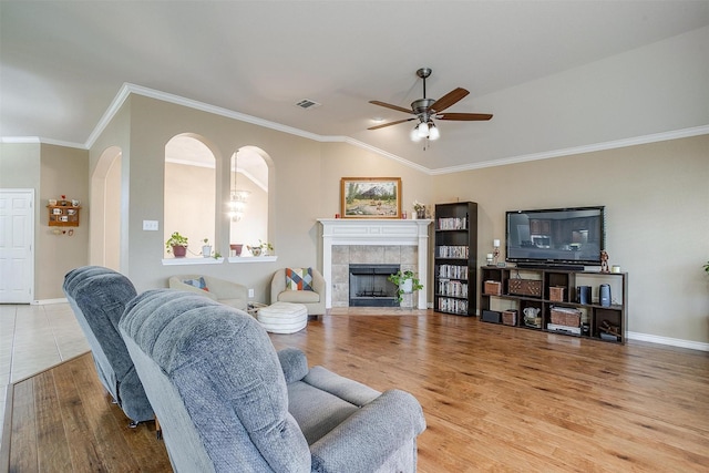 2134 Lorrie Ln, Weatherford, TX 76087 - living area featuring a ceiling fan, a fireplace, ornamental molding, baseboards, and wood finished floors