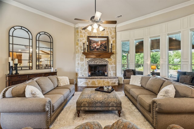 305 Crestfield Ct, Sunnyvale, TX 75182 - living room featuring ornamental molding, a ceiling fan, a stone fireplace, and wood finished floors