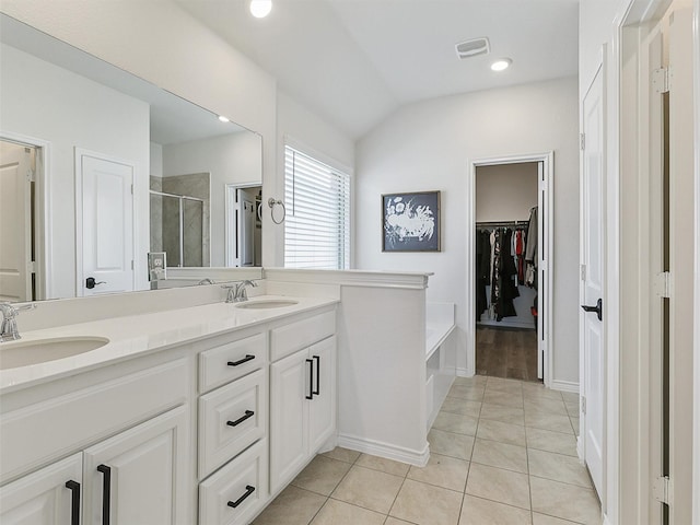 505 Maverick St, Anna, TX 75409 - full bathroom featuring a stall shower, double vanity, vaulted ceiling, tile patterned floors, and a bath