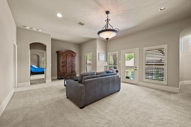609 Deerwood Ln, Keller, TX 76248 - living area featuring light carpet, arched walkways, healthy amount of natural light, baseboards, and recessed lighting