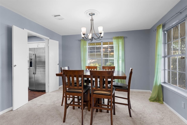 2118 Wooded Acres Dr, Waco, TX 76710 - carpeted dining room with a chandelier and baseboards