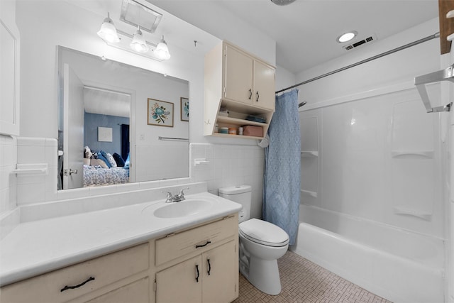 2118 Wooded Acres Dr, Waco, TX 76710 - ensuite bathroom with toilet, tile patterned floors, vanity, tile walls, and shower / bath combination with curtain