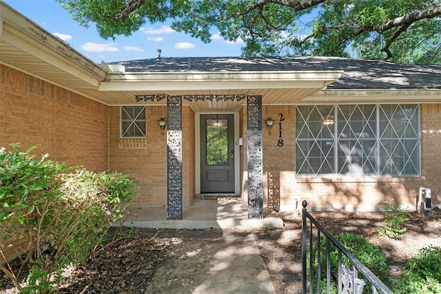 2118 Wooded Acres Dr, Waco, TX 76710 - property entrance with brick siding and a shingled roof