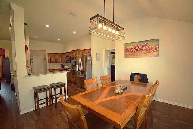 2851 Cobblestone Dr, Rockwall, TX 75087 - dining area featuring dark wood-type flooring, lofted ceiling, baseboards, and recessed lighting