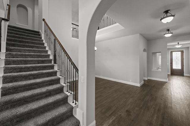 612 Wildriver Trl, Fort Worth, TX 76131 - entrance foyer with arched walkways, baseboards, dark wood-style floors, and stairs