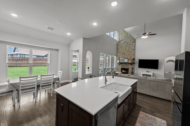 612 Wildriver Trl, Fort Worth, TX 76131 - kitchen featuring a sink, dishwasher, a ceiling fan, a stone fireplace, and healthy amount of natural light