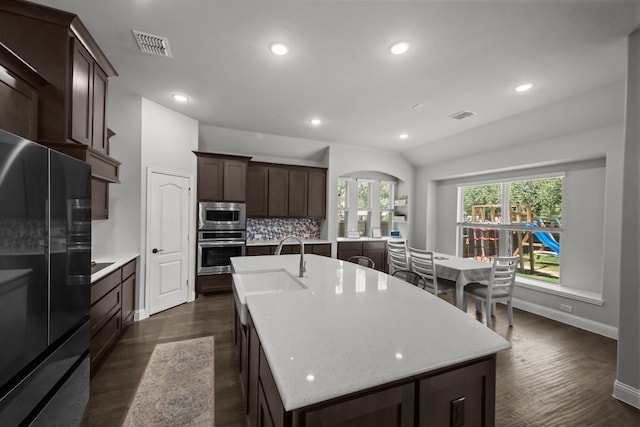 612 Wildriver Trl, Fort Worth, TX 76131 - kitchen with appliances with stainless steel finishes, dark wood finished floors, an island with sink, dark brown cabinets, and recessed lighting