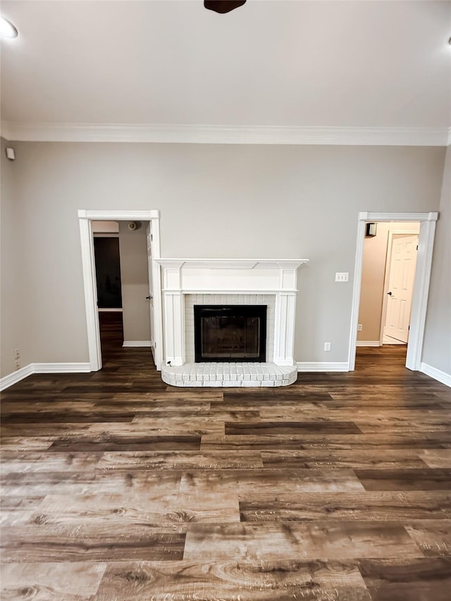 107 Summit Dr, Bossier City, LA 71111 - unfurnished living room featuring crown molding, baseboards, dark wood finished floors, and a fireplace