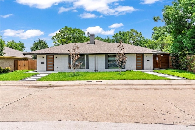 3649 Stables Ln, Dallas, TX 75229 - mid-century home featuring a chimney and brick siding