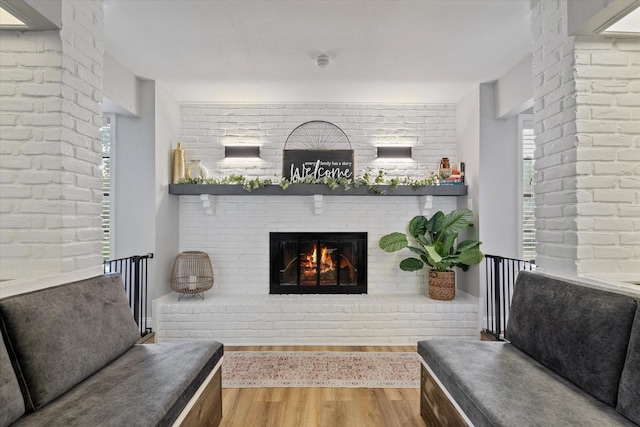 7204 Kingswood Dr, Fort Worth, TX 76133 - living area with wood finished floors, a fireplace, and brick wall