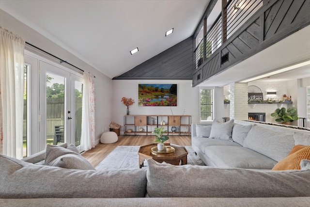 7204 Kingswood Dr, Fort Worth, TX 76133 - living room featuring healthy amount of natural light, wood finished floors, high vaulted ceiling, and a brick fireplace
