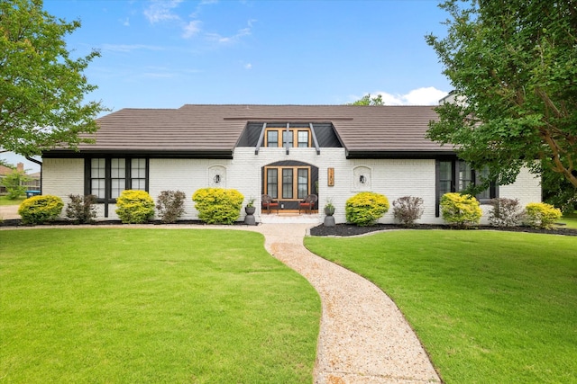 7204 Kingswood Dr, Fort Worth, TX 76133 - view of front of property featuring brick siding, a front yard, french doors, and a patio area