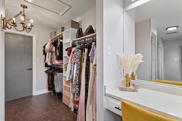 7204 Kingswood Dr, Fort Worth, TX 76133 - walk in closet with dark tile patterned floors and a chandelier