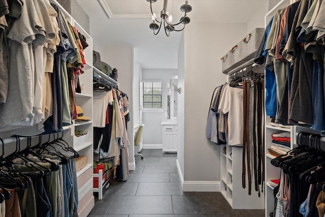 7204 Kingswood Dr, Fort Worth, TX 76133 - walk in closet featuring dark tile patterned flooring and a chandelier
