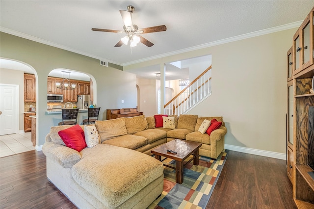 4406 Westcreek Ln, Sachse, TX 75048 - living room with arched walkways, ceiling fan, wood finished floors, stairs, and ornamental molding