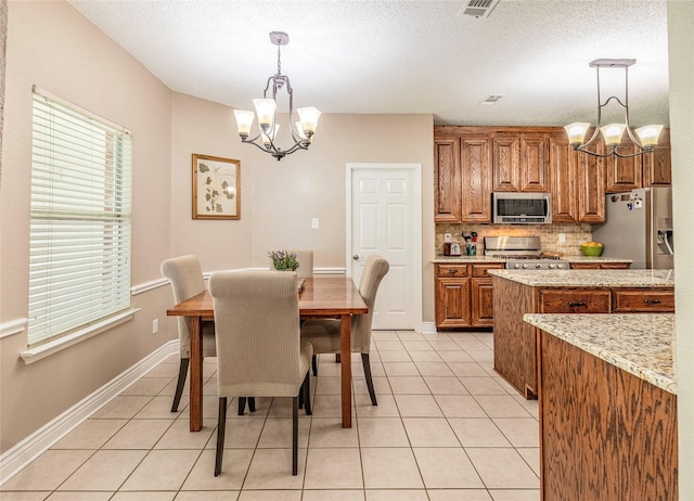 4406 Westcreek Ln, Sachse, TX 75048 - dining room featuring a chandelier, light tile patterned flooring, baseboards, and a textured ceiling