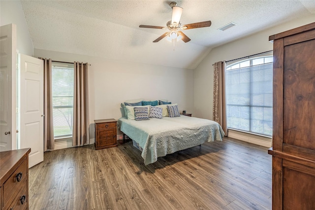 4406 Westcreek Ln, Sachse, TX 75048 - bedroom featuring lofted ceiling, wood finished floors, a textured ceiling, and a ceiling fan