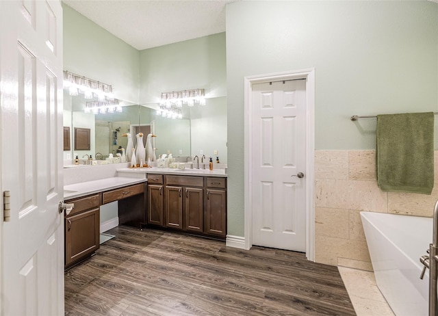4406 Westcreek Ln, Sachse, TX 75048 - full bathroom featuring a freestanding bath, vanity, and wood finished floors