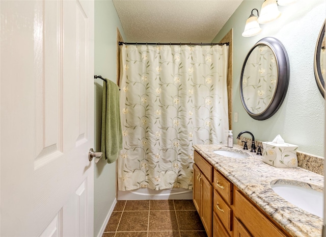 4406 Westcreek Ln, Sachse, TX 75048 - bathroom featuring double vanity, tile patterned flooring, a textured ceiling, and shower / tub combo