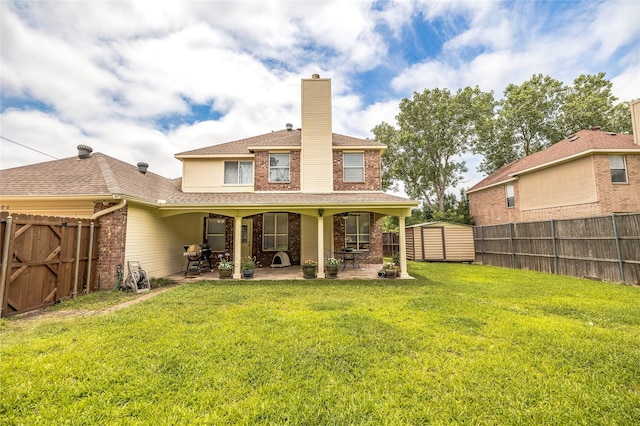 4406 Westcreek Ln, Sachse, TX 75048 - back of property with a patio area, a chimney, a shingled roof, and brick siding