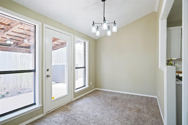 5630 Cancun Dr, North Richland Hills, TX 76180 - unfurnished dining area with carpet, plenty of natural light, a chandelier, baseboards, and a textured ceiling