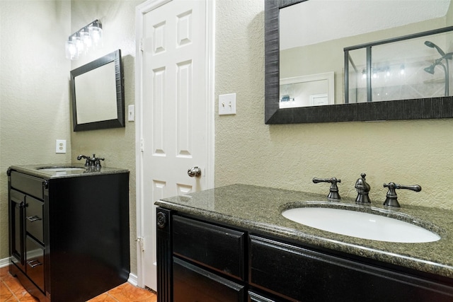 5630 Cancun Dr, North Richland Hills, TX 76180 - bathroom featuring a textured wall, two vanities, and tile patterned flooring