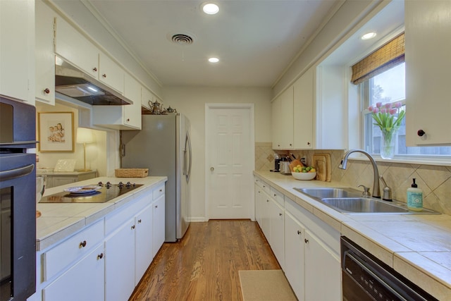 4200 Bilglade Rd, Fort Worth, TX 76109 - kitchen featuring black appliances, a sink, tile counters, dark wood finished floors, and recessed lighting