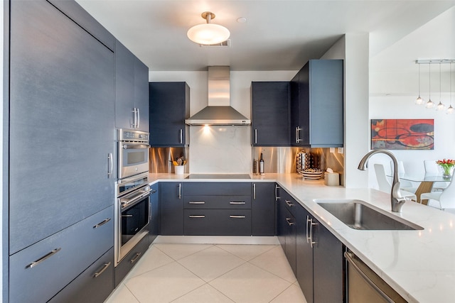 3111 Welborn St Unit 1303, Dallas, TX 75219 - kitchen with a sink, wall chimney range hood, light stone countertops, light tile patterned floors, and decorative backsplash