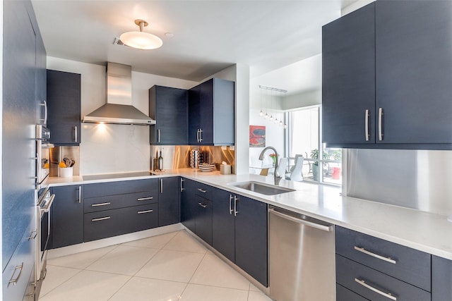 3111 Welborn St Unit 1303, Dallas, TX 75219 - kitchen with stainless steel appliances, wall chimney range hood, a sink, light countertops, and light tile patterned floors