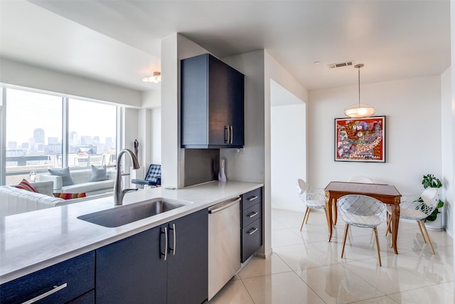 3111 Welborn St Unit 1303, Dallas, TX 75219 - kitchen with dishwasher, a sink, light countertops, hanging light fixtures, and blue cabinets