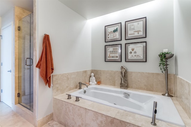 3111 Welborn St Unit 1303, Dallas, TX 75219 - bathroom featuring a bath, a stall shower, and tile patterned flooring