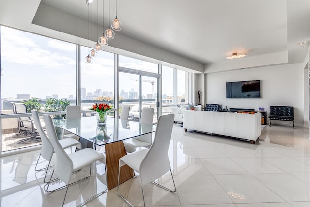 3111 Welborn St Unit 1303, Dallas, TX 75219 - dining room featuring light tile patterned floors and a tray ceiling